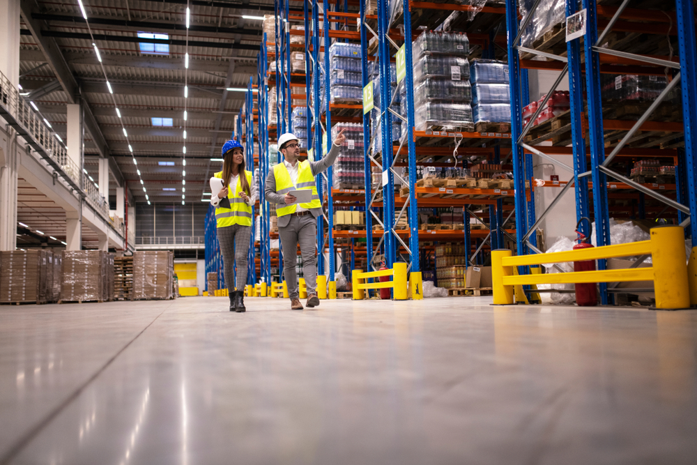 Warehouse,Managers,Walking,In,A,Large,Storage,Department,Controlling,Distribution